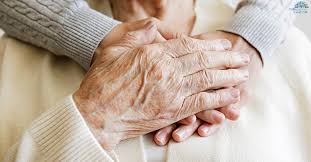 Young hand holding elderly hand
